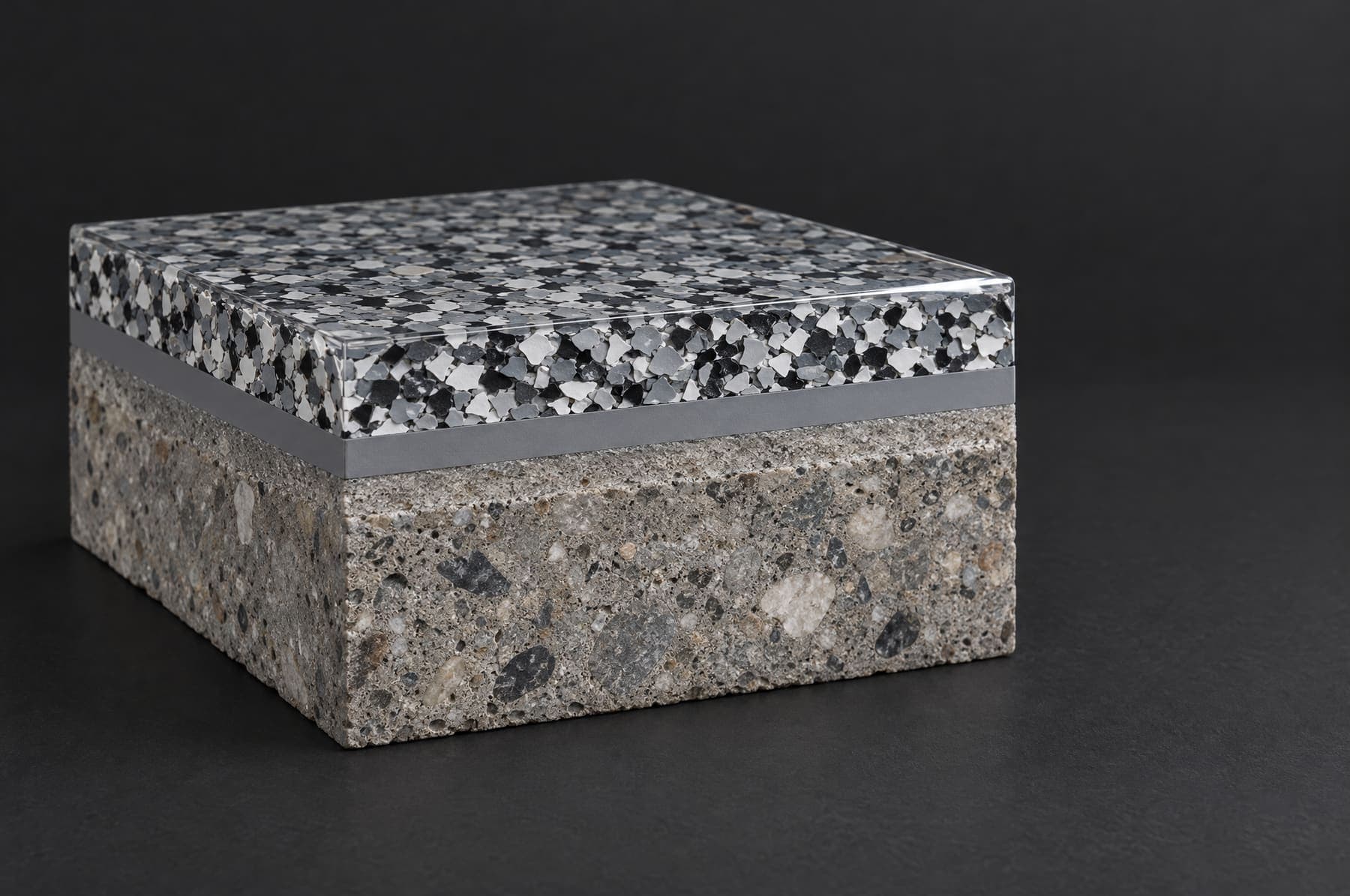 Cutaway block showing concrete, a gray base coat, a layer of gray, white and black flake, and a clear glossy topcoat